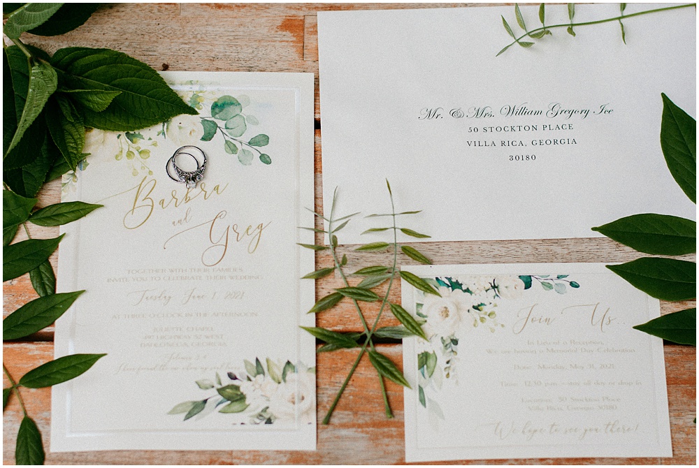 flowery branch wedding photographer takes pictures of the wedding invitations at Juliette Chapel, a wedding venue in Dahlonega, Ga, hidden wooded wedding venue 