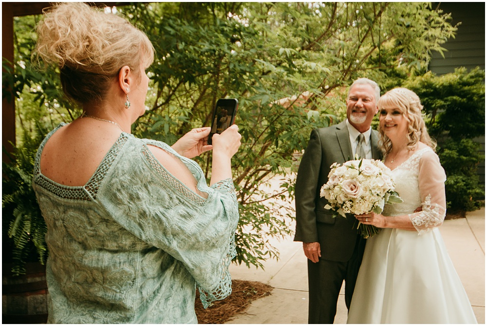 flowery branch wedding photographer takes pictures of the wedding ceremony at Juliette Chapel, a wedding venue in Dahlonega, Ga, hidden wooded wedding venue 