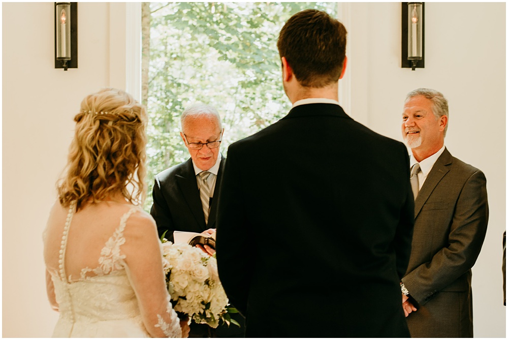 flowery branch wedding photographer takes pictures of the wedding ceremony at Juliette Chapel, a wedding venue in Dahlonega, Ga, hidden wooded wedding venue 