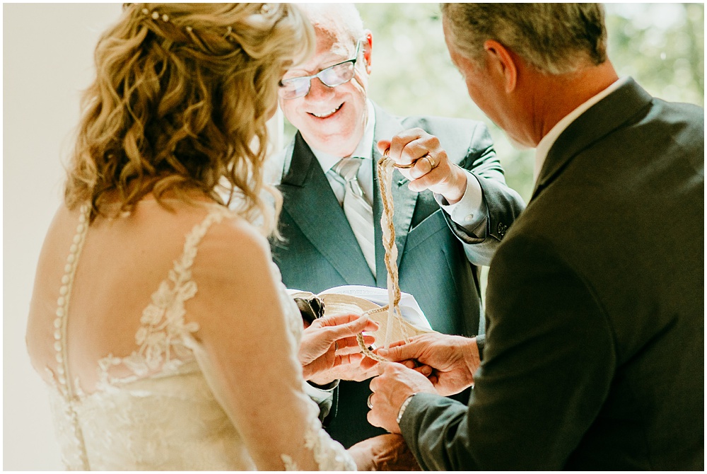 flowery branch wedding photographer takes pictures of the wedding ceremony at Juliette Chapel, a wedding venue in Dahlonega, Ga, hidden wooded wedding venue 