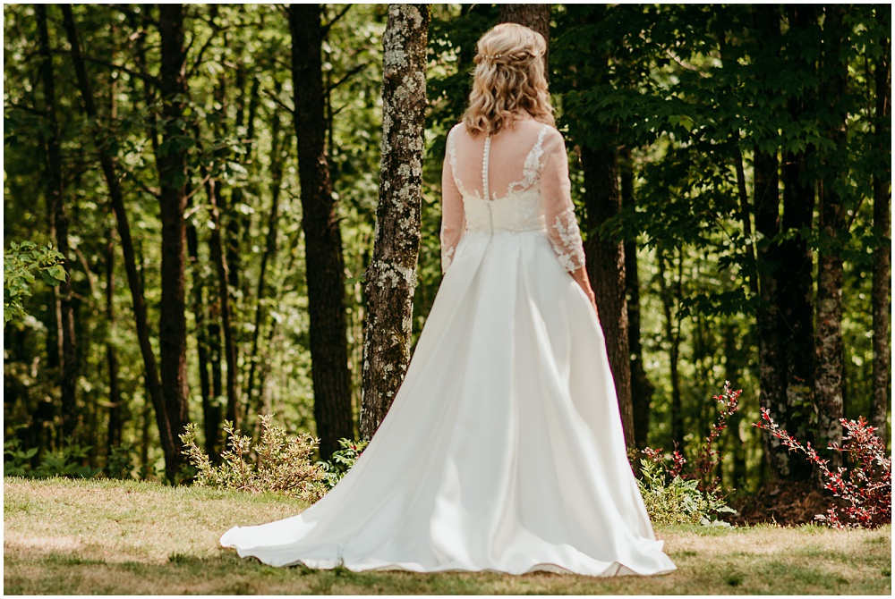 flowery branch wedding photographer takes pictures of the Brides wedding dress at Juliette Chapel, a wedding venue in Dahlonega, Ga, hidden wooded wedding venue 