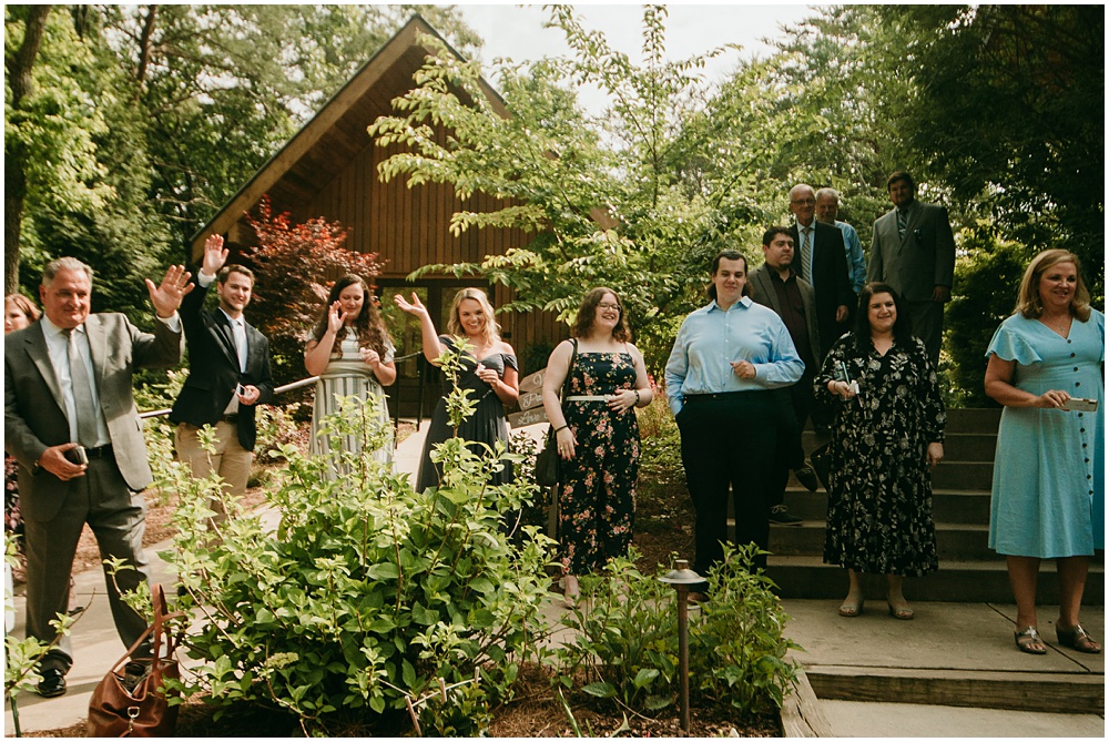 flowery branch wedding photographer takes pictures of the Bride and Grooms exit at Juliette Chapel, a wedding venue in Dahlonega, Ga, hidden wooded wedding venue 