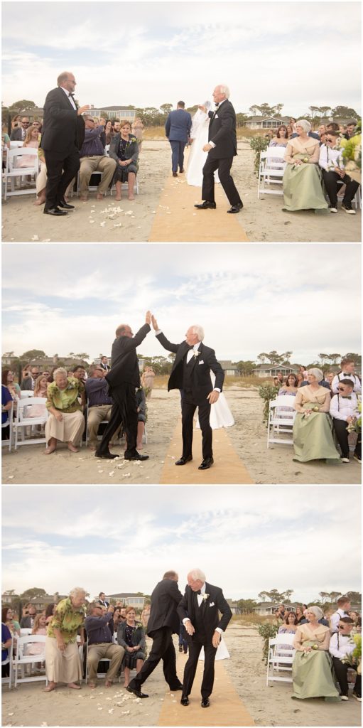 Bride + Groom's parents high five each other after the wedding ceremony on the beach