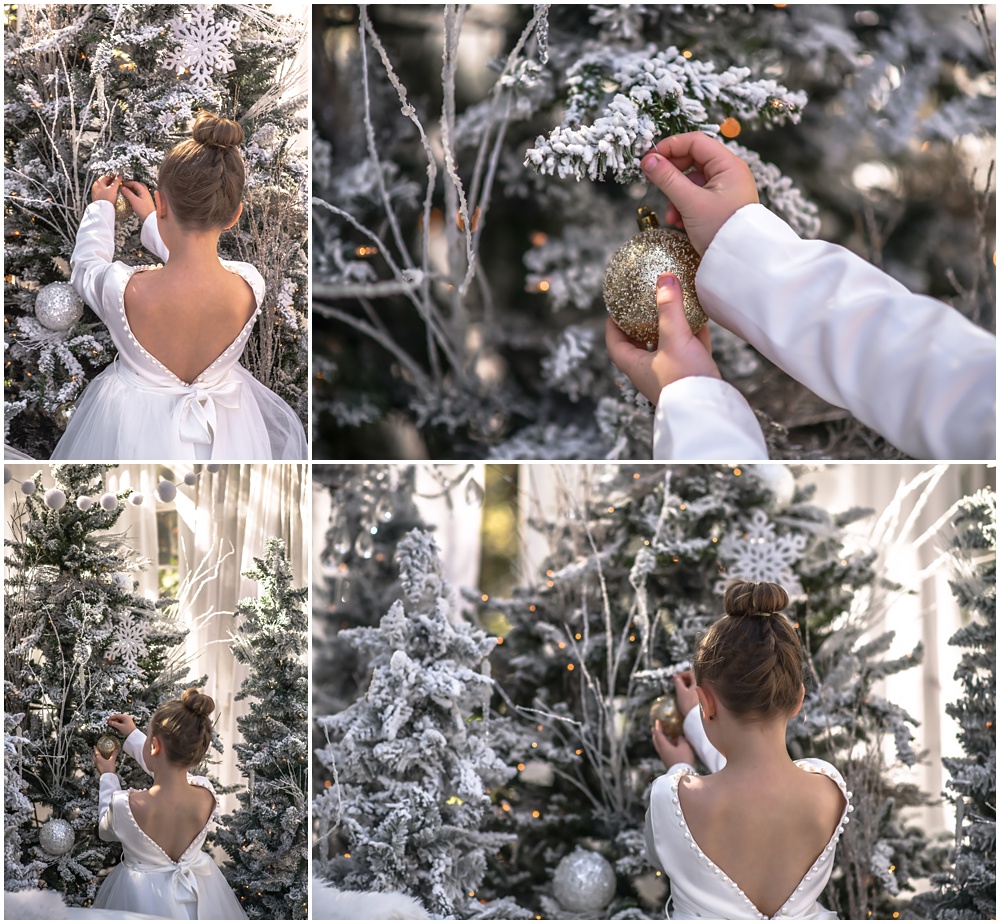 little girl decorating the Christmas tree during her enchanted mini session at Mayberry Acres in Canton, Ga