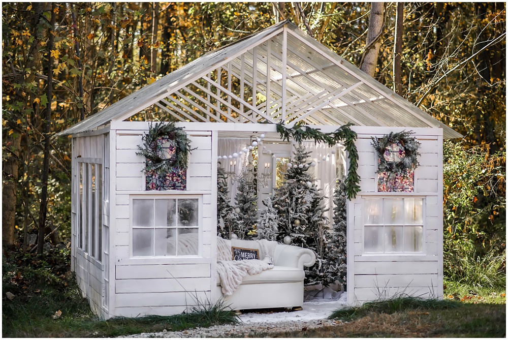 white, wooden, enchanted greenhouse, filled with frosted Christmas trees located at Mayberry Acres, in Canton, Ga