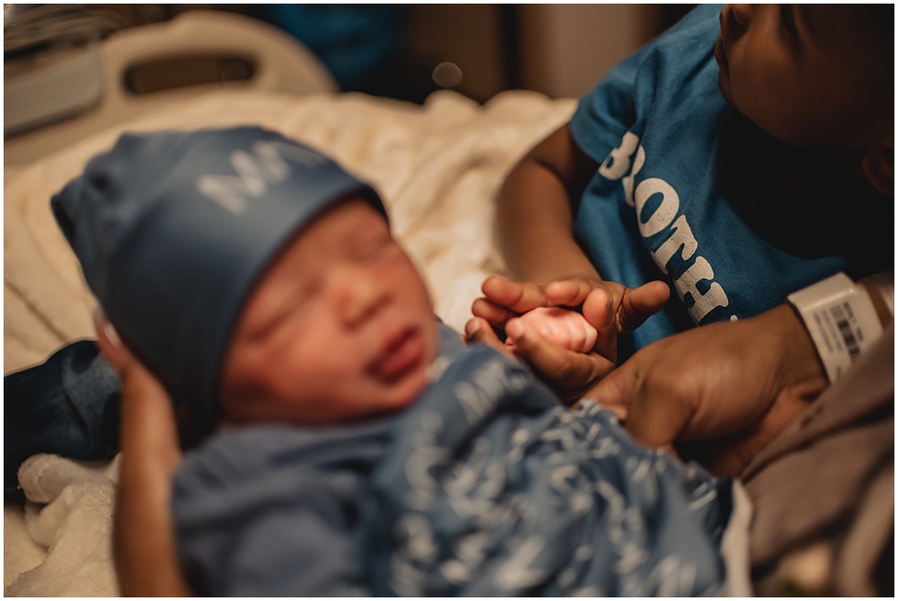 newborn baby at Northeast georgia medical. Family poses with the baby during their fresh 48 session in lawrenceville ga