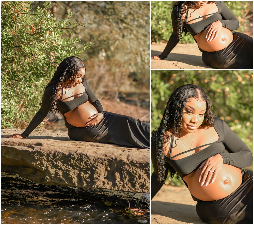 maternity session at Gerrard Landing Park in Roswell, Georgia. Mom is wearing a black dress with the stomach open for viewing. Mom is sitting on a big rock with her hands on her belly