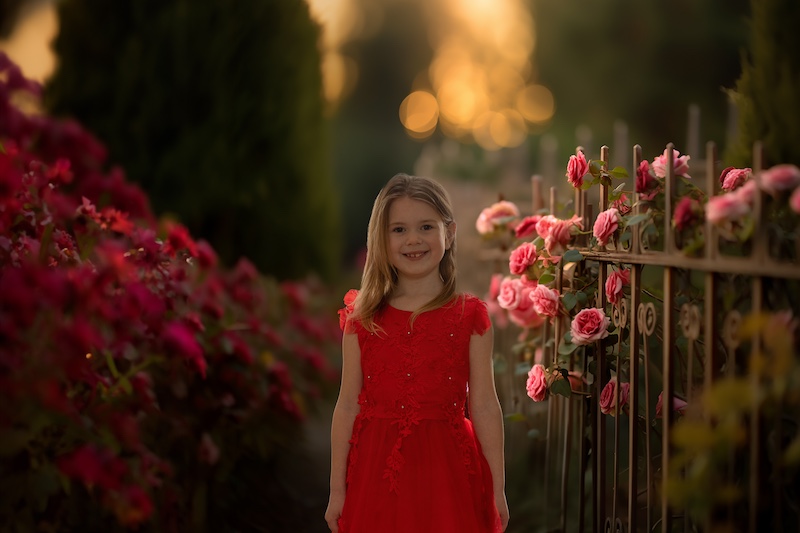 valentines composite of a girl beside flower bush 