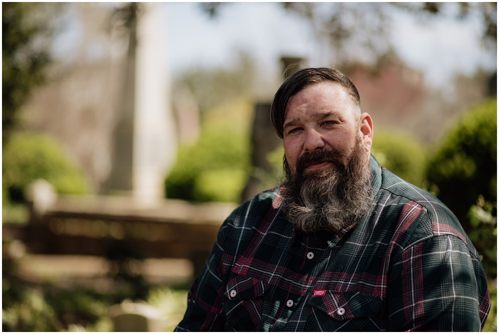 Groom posing during an engagement session at Oakland Cemetery in Atlanta georgia. Goth bride 2025