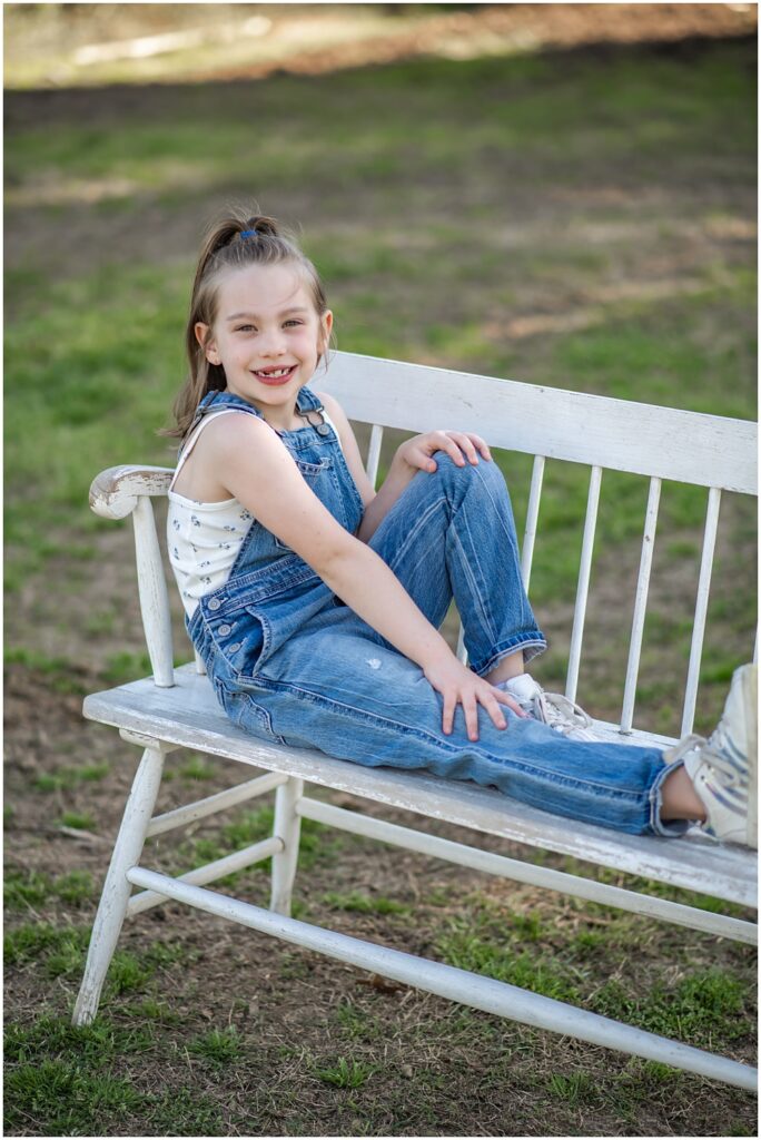 Flowery Branch photographer hosts mini session of little girl playing with baby goats. She takes a time out for solo photos of herself at Prospect Farms, Lawrenceville, Ga. 