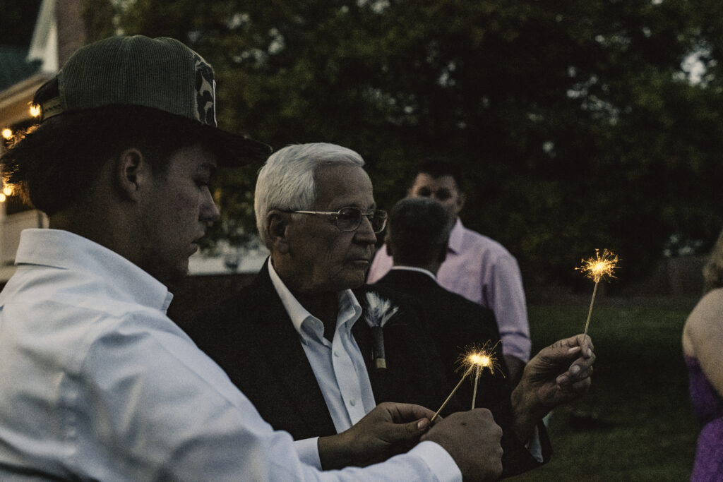 North Georgia photographer photographs a wedding in the country for a young couple in the north Georgia mountains. Photographed here are the guests holding their sparklers