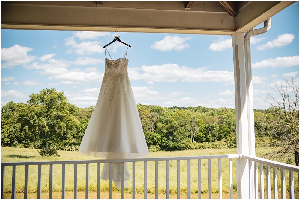 North Georgia photographer photographs the Bride's wedding dress on the front porch of their intimate wedding