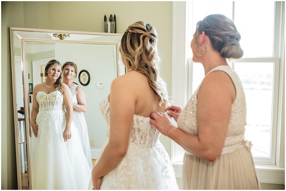 North Georgia photographer photographs the Bride's mom helping her button her wedding dress